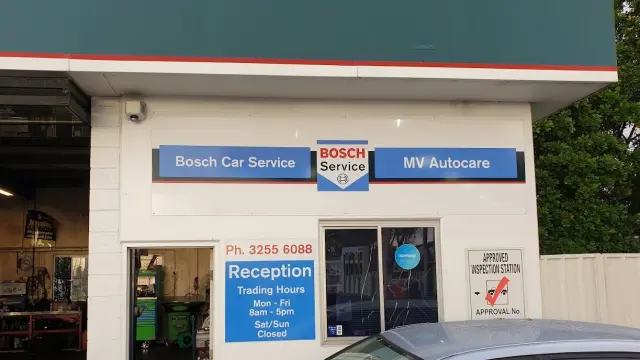 Interior view of Bosch Car Service reception area with business hours sign, inviting customers to book services.