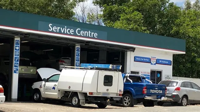 Facade of MV Auto Care service center with Bosch Car Service branding, located at a service station