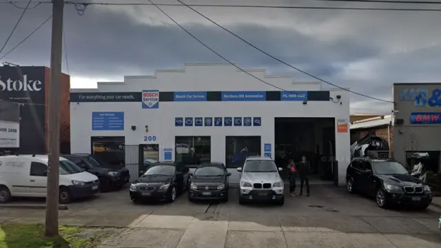 View of a car service workshop from the street, showcasing the entrance to Northern BM's reputable car repair and maintenance facility.