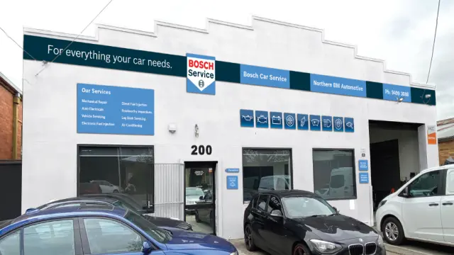 Street view of a professional mechanic's workshop with clear signage for Northern BM, known for expert car service and repairs.