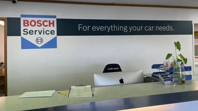 Reception area inside Bosch Car Service workshop, featuring the welcoming desk and customer service area.