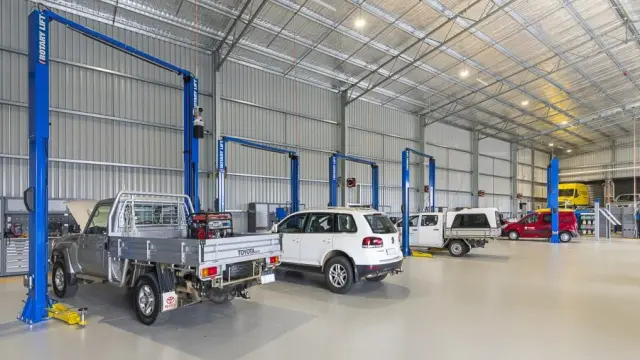 Bosch Car Service facility showcasing state-of-the-art diagnostic equipment and skilled mechanics working on vehicles.
