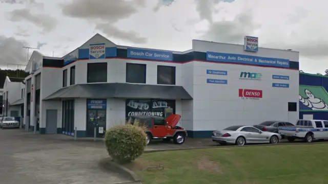 Daytime street view of our mechanic workshop front, showcasing the modern facility ready for car service and repair.