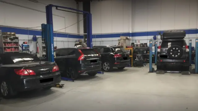 Busy car service workshop in Castle Hill, with skilled mechanics working on vehicles