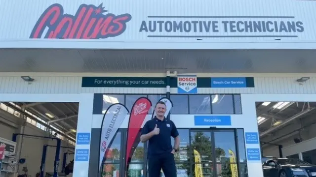 Owner of Collins Automotive standing in front of his business in central Hamilton.