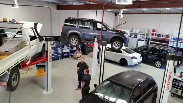 Inside the workshops of Bosch Car Service Port Kennedy, where expert mechanics diligently service multiple cars.